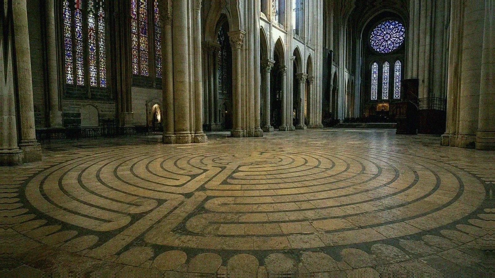 Chartres Cathedral floor labyrinth inside the Gothic nave with stained-glass light